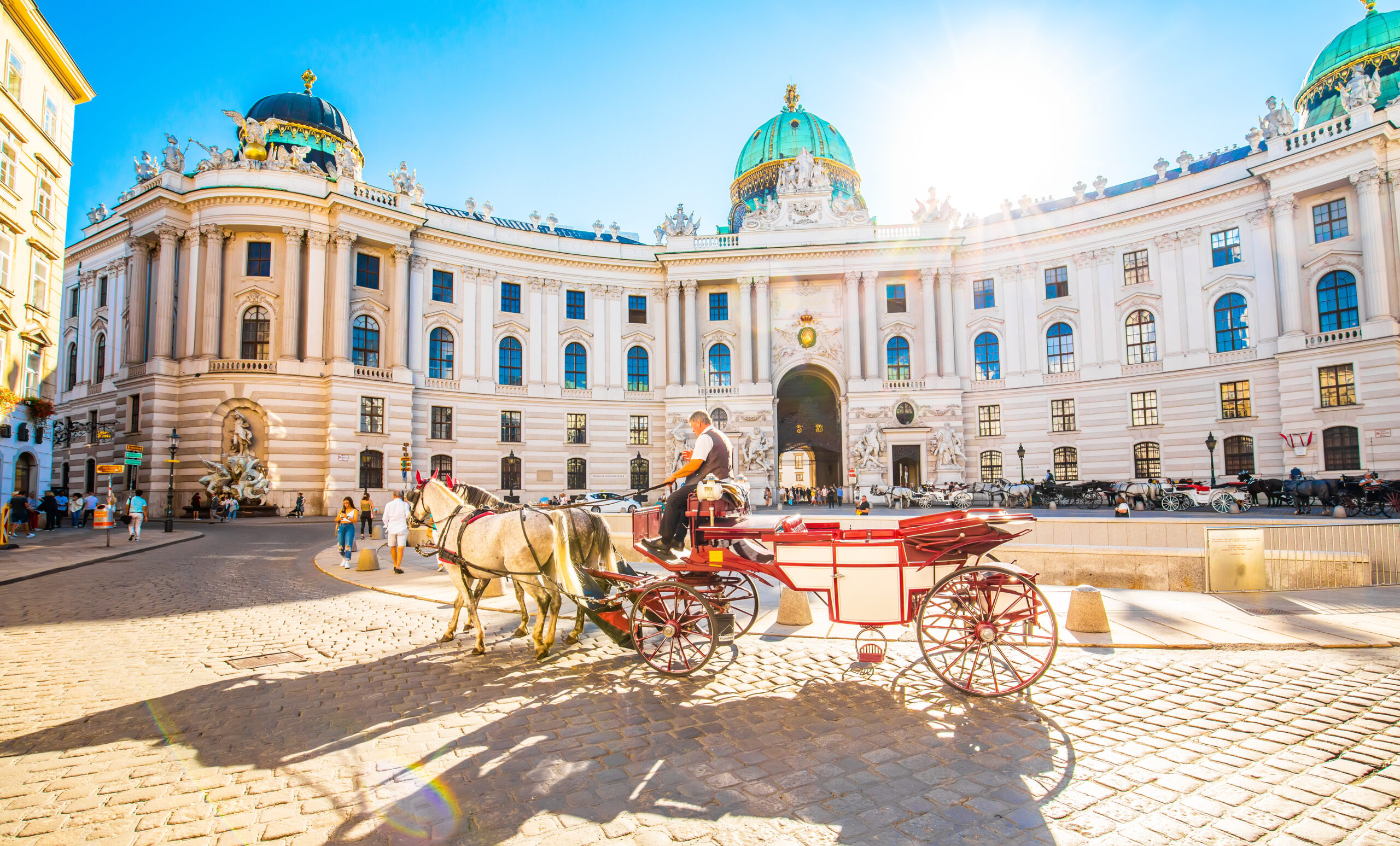 Hofburg Palace and horse carriage on sunny Vienna street, Austri